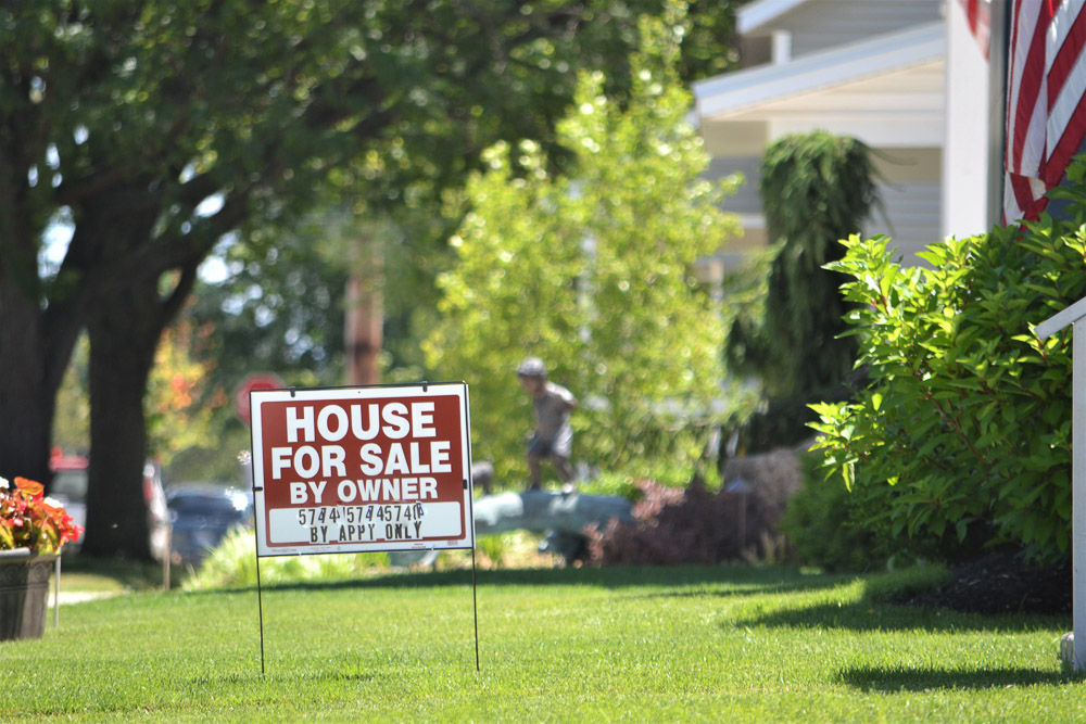 House for sale sign in the front yard